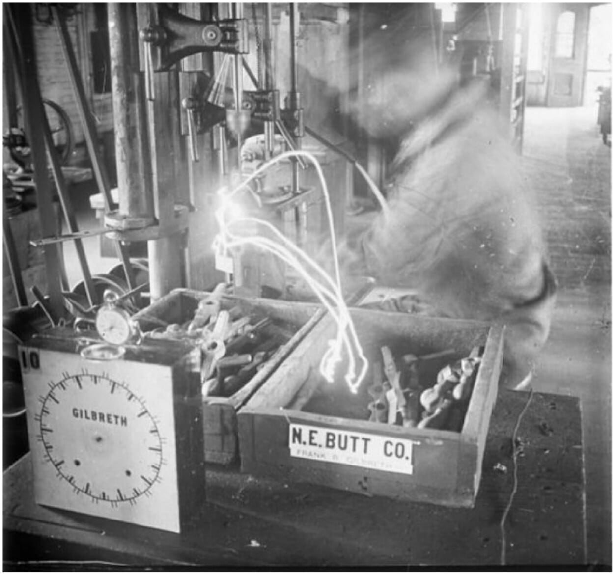 A long-exposure image showing the motion of a worker over time
